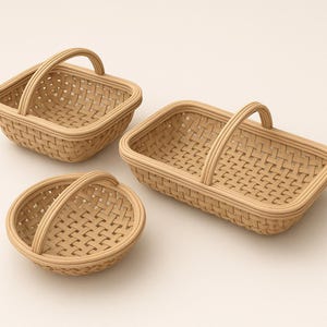 May include: Three woven baskets in varying shapes: a square, a rectangle, and a circle. Each basket has a handle and a light brown color. The baskets are made of a woven material, likely rattan or wicker.