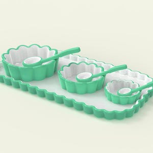 May include: A serving set with a scalloped edge tray and matching bowls in varying sizes. The bowls and spoons are a bright teal color with white interiors. The set includes three bowls and three spoons.
