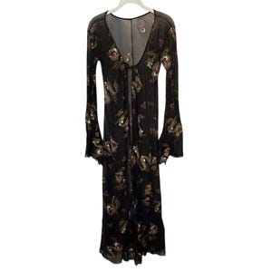 May include: A long, black, open-front dress with a V-neck and long, flared sleeves. The dress is adorned with a floral pattern in shades of gold and brown. The fabric appears sheer and lightweight, suitable for layering.