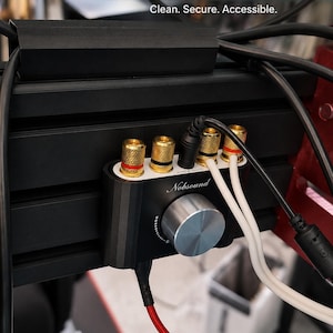 May include: A black 3D printed Nobsound mini amp mount for 20x20 / 8020 profile aluminium extrusions. The mount secures a black Nobsound amplifier with a silver volume knob, gold-coloured terminals, and various connected cables to a black metal frame.