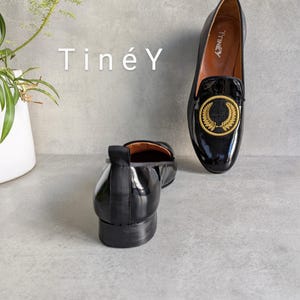 Handmade Women Shoes with Gold Color Crest Embroidered, Soft Natural Leather Lining for Comfort and Durability, Detailed Hand-Crafted Loafers, Classic Black Leather with a Modern Twist.