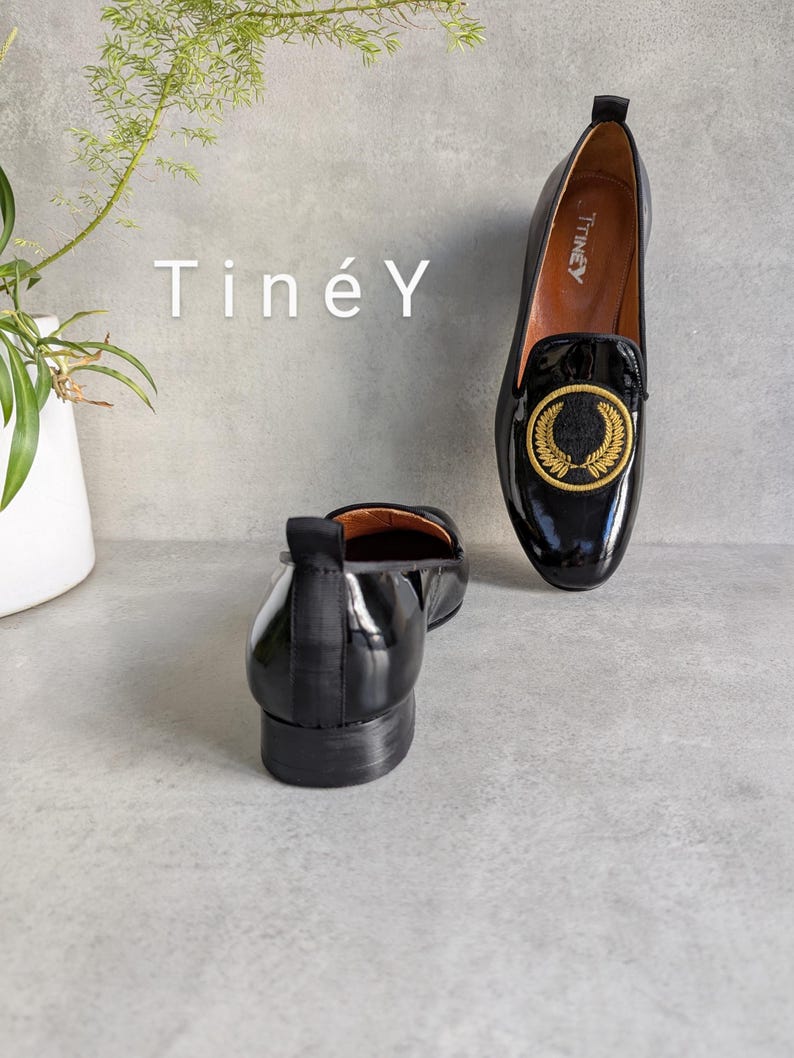Handmade Women Shoes with Gold Color Crest Embroidered, Soft Natural Leather Lining for Comfort and Durability, Detailed Hand-Crafted Loafers, Classic Black Leather with a Modern Twist.