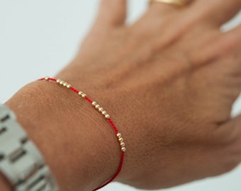 SOLID 14K GOLD delicate friendship bracelet on red silk cord, modern bracelet, minimalist bracelet