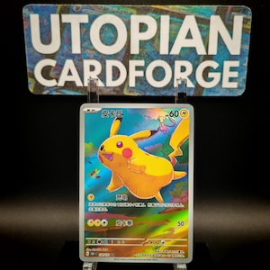 May include: A holographic Pikachu trading card with a yellow and red design. The card features the text "皮卡丘" and "60". The card is displayed in a clear holder with the text "UTOPIAN CARDFORGE" in the background.