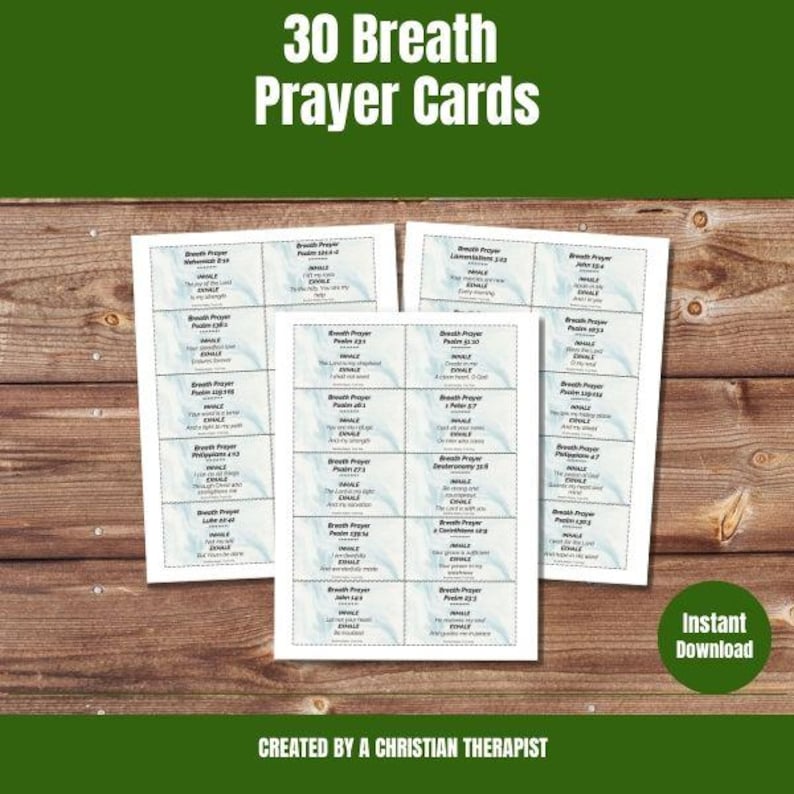 May include: Three white rectangular prayer cards with a light blue border are displayed on a wooden surface. Each card features multiple smaller rectangles with text. The top of the image reads "30 Breath Prayer Cards". The bottom of the image reads "Created by a Christian Therapist".