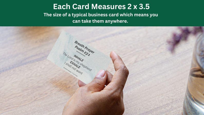 May include: A business card held in a hand, featuring the text "Breath Prayer Psalm 23:1" with "INHALE" and "EXHALE" instructions. The card measures 2 x 3.5 inches. The background includes a wooden surface and a glass vase.