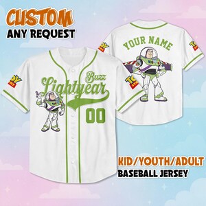 May include: White baseball jersey with green accents and Buzz Lightyear graphics. The front features "Buzz Lightyear" and the number "00". The back has "YOUR NAME" and a Buzz Lightyear image. Text on the top says "CUSTOM ANY REQUEST".