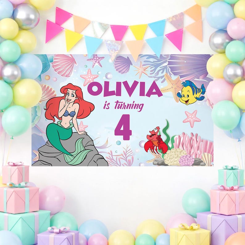 May include: A rectangular party backdrop featuring a cartoon mermaid with red hair, a yellow fish, and a red crab. The text reads OLIVIA is turning 4. The background displays an underwater scene with seashells, starfish, and coral, framed by colorful balloons and a triangular bunting banner.