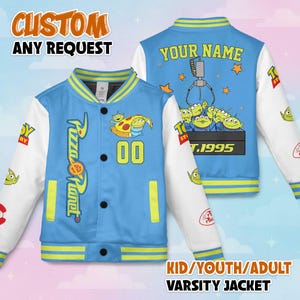 May include: A light blue varsity jacket with white sleeves and yellow accents. The front features a Pizza Planet logo and the number 00. The back has a claw machine graphic and the text "YOUR NAME". The jacket is labeled "CUSTOM ANY REQUEST".