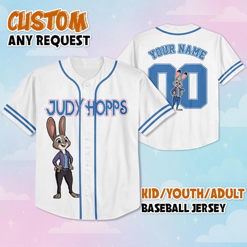May include: A white baseball jersey with blue trim, featuring a graphic of Judy Hopps on the front and the text Judy Hopps. The back displays the text Your Name, the number 00, and a graphic of Judy Hopps. The jersey has a button-down front.