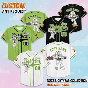 May include: Baseball jerseys in green, black, and white, featuring the Buzz Lightyear character. Each jersey has the text "Buzz Lightyear" and the number "00". The jerseys are available in kid, youth, and adult sizes. The text "CUSTOM ANY REQUEST" is at the top.