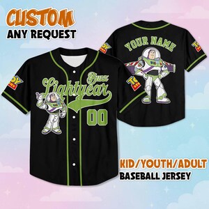 May include: Black baseball jersey with green accents featuring Buzz Lightyear graphics. The front displays "Buzz Lightyear" and the number "00". The back has "YOUR NAME" and a Buzz Lightyear image. Text at the top says "CUSTOM ANY REQUEST" and at the bottom "KID/YOUTH/ADULT BASEBALL JERSEY".