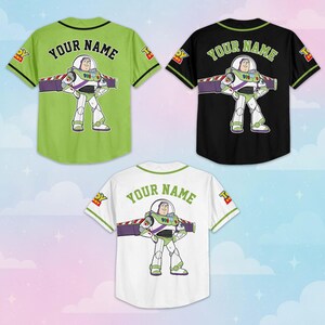 May include: Three baseball-style jerseys in green, black, and white. Each jersey features a Buzz Lightyear graphic and the text "YOUR NAME" across the back. The jerseys have contrasting color sleeves and trim.