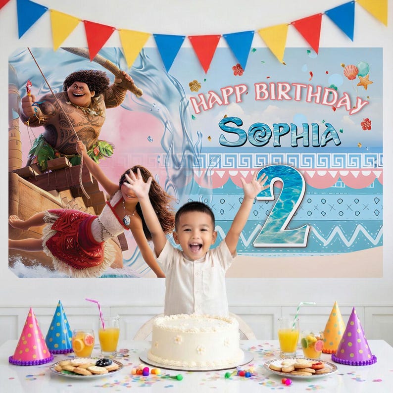 May include: A birthday party backdrop featuring Moana and Maui characters, the text "HAPP BIRTHDAY SOPHIA", and a large number "2". The scene includes a white cake, colorful party hats, and a banner of triangular flags in blue, yellow, and red.
