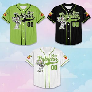 May include: Three baseball jerseys in green, black, and white, each featuring a Buzz Lightyear graphic and the text "Buzz Lightyear" in a stylized font. The number "00" is displayed on the front of each jersey.