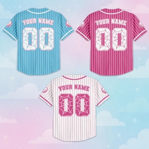 May include: Three baseball jerseys in blue, pink, and white, each with vertical stripes. The jerseys display "YOUR NAME" above the number "00" in a stylized font. Each jersey has a spiderweb design on the number.