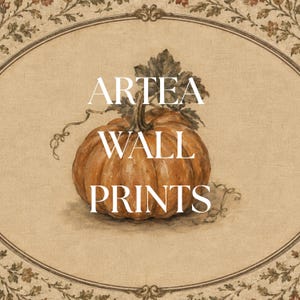 May include: A wall print featuring a central orange pumpkin with green leaves and vines, set within an oval frame decorated with floral motifs. The text ARTEA WALL PRINTS is centered in white capital letters over the pumpkin illustration.