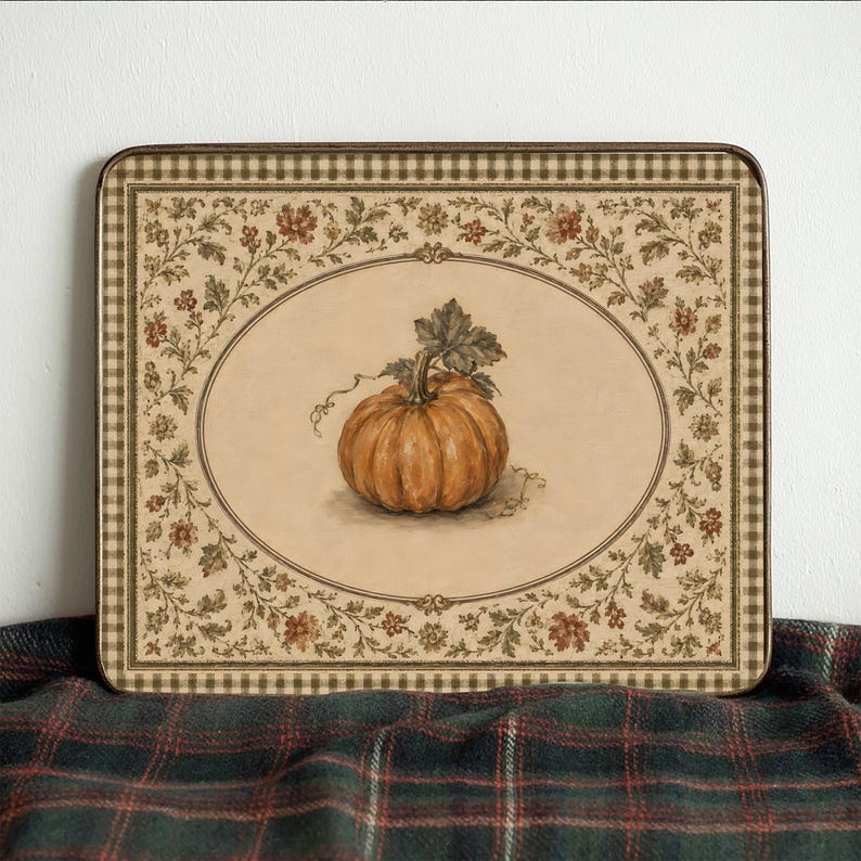May include: A rectangular serving tray featuring a central illustration of an orange pumpkin within an oval frame. The border displays a brown and cream checkered pattern and a decorative floral vine motif in shades of green, brown, and red.