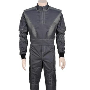 Puede incluir: Mono de carreras gris con cuello alto y mangas largas. El mono presenta paneles grises en contraste y costuras blancas. Pu&ntilde;os negros visibles en las mu&ntilde;ecas. Dise&ntilde;ado para deportes de motor.