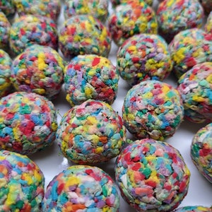 May include: A collection of colorful, handmade, confetti-filled balls. Each ball is made of a variety of colors, including red, blue, green, yellow, and purple. The balls are all about the same size and are arranged in a random pattern.