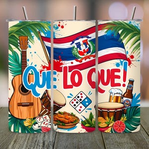 May include: A stainless steel tumbler featuring a vibrant design with a guitar, drums, dominoes, and the Dominican Republic flag. The text "QUE LO QUE!" is prominently displayed. The design includes images of food and drinks.