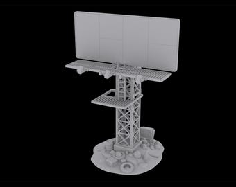 May include: A gray, unpainted miniature model of a billboard structure featuring a rectangular display panel, a central lattice support tower, and a platform. The base is detailed with scattered debris, including small boxes, barrels, and circular objects.