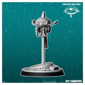 May include: A gray miniature robot figure on a stand, with a detailed head and multiple mechanical components. The base is a circular platform with a textured surface. The text "VERMILION MINIATURES" and "pre-supported" are visible.