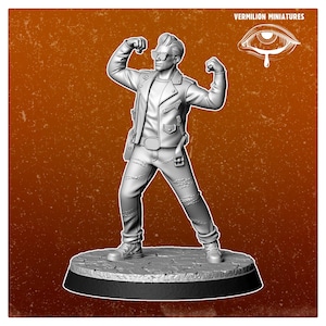Könnte beinhalten: Graue Miniaturfigur einer Person in Lederjacke, Jeans und Sonnenbrille, die ihre Arme anspannt. Die Figur steht auf einem runden Sockel. Der Text "VERMILION MINIATURES" und ein Augenlogo befinden sich in der oberen rechten Ecke.