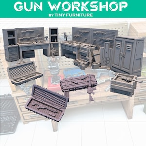 May include: A collection of miniature gun workshop models, including workbenches, storage cabinets, and weapon cases. The models are gray and feature detailed designs, with the text "GUN WORKSHOP BY TINY FURNITURE" at the top.