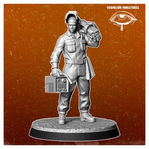 May include: A gray miniature figurine of a person in a welding uniform, holding a welding machine and a large welding glove. The figurine is standing on a circular base. The text "VERMILION MINIATURES" and an eye logo are in the upper right corner.