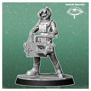 May include: A grey miniature figure of an astronaut with a cracked helmet revealing a skull, holding a large rectangular mechanical device. The figure stands on a circular base. The text Vermilion Miniatures and an eye icon are visible.