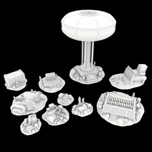 May include: A collection of white 3D-printed miniature terrain pieces, including a large domed structure on a pedestal, several small buildings, and scattered debris. The pieces are designed for tabletop gaming or model building.