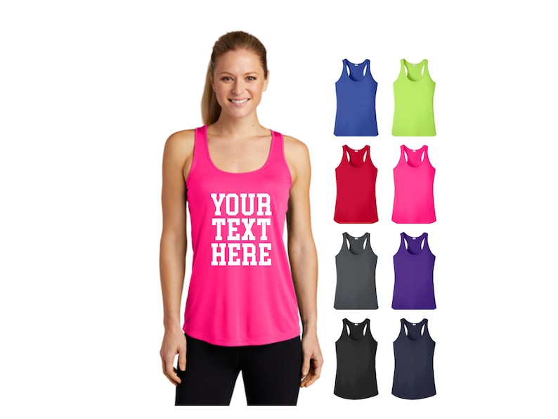 May include: A pink tank top with the text "YOUR TEXT HERE" in white. The tank top is shown on a model. There are eight additional tank tops in different colors shown below the model.