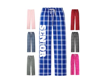 May include: A collection of plaid pajama pants in various colors including blue, pink, red, black, and white. The central blue pair features the white text SENIOR 2027 printed vertically down the leg. Each pair has an elastic waistband with a drawstring.