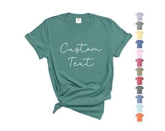 May include: Teal blue t-shirt with the text "Custom Text" in white.