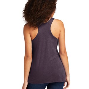 May include: A dark purple sleeveless tank top made of a soft, comfortable fabric. The tank top has a relaxed fit and a scoop neck.