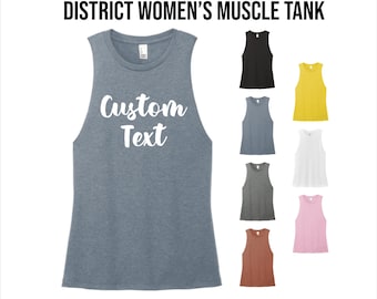 May include: A heather gray muscle tank with the text "Custom Text" in white. The image also shows examples of the tank in black, blue, yellow, white, gray, pink, and brown.