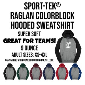 May include: A hooded sweatshirt with a color block design. The sweatshirt is available in a variety of colors, including black, green, red, and navy blue. The sweatshirt is made of a 65/35 ring spun combed cotton/poly fleece blend and is available in sizes XS-4XL. "Your Text Here" is printed on the front of the sweatshirt.