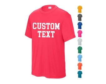May include: A bright pink t-shirt with the text "CUSTOM TEXT" in white. The shirt is available in a variety of colors.
