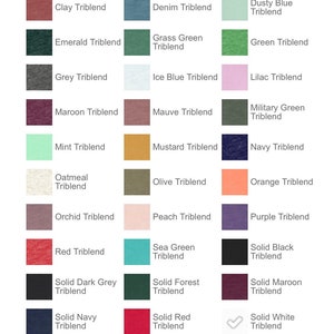 May include: A color chart of 36 different triblend t-shirt colors. The colors are arranged in rows of six, with each color labeled with its name. The colors include aqua, athletic grey, berry, black heather, blue, brick, cardinal, charcoal-black, clay, denim, dusty blue, emerald, grass green, green, grey, ice blue, lilac, maroon, mint, mustard, navy, oatmeal, olive, orchid, peach, orange, purple, red, solid dark grey, solid navy, sea green, solid forest, solid red, solid black, solid maroon, solid white, steel blue, storm, tan, teal, sunset, true royal, white fleck, and yellow gold.