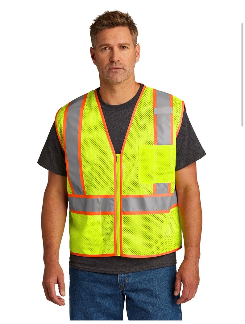 May include: A yellow safety vest with orange and silver reflective strips. The vest has a zipper closure and a mesh design.