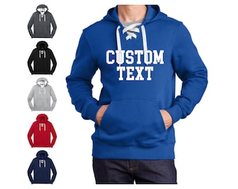May include: A royal blue hoodie with a white lace-up detail at the neckline. The hoodie has a kangaroo pocket and the text "CUSTOM TEXT" printed in white on the front.