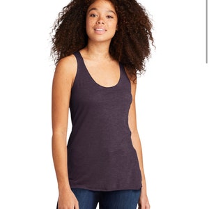 May include: A dark purple sleeveless tank top with a scoop neck. The tank top is made of a soft, comfortable fabric and has a relaxed fit.
