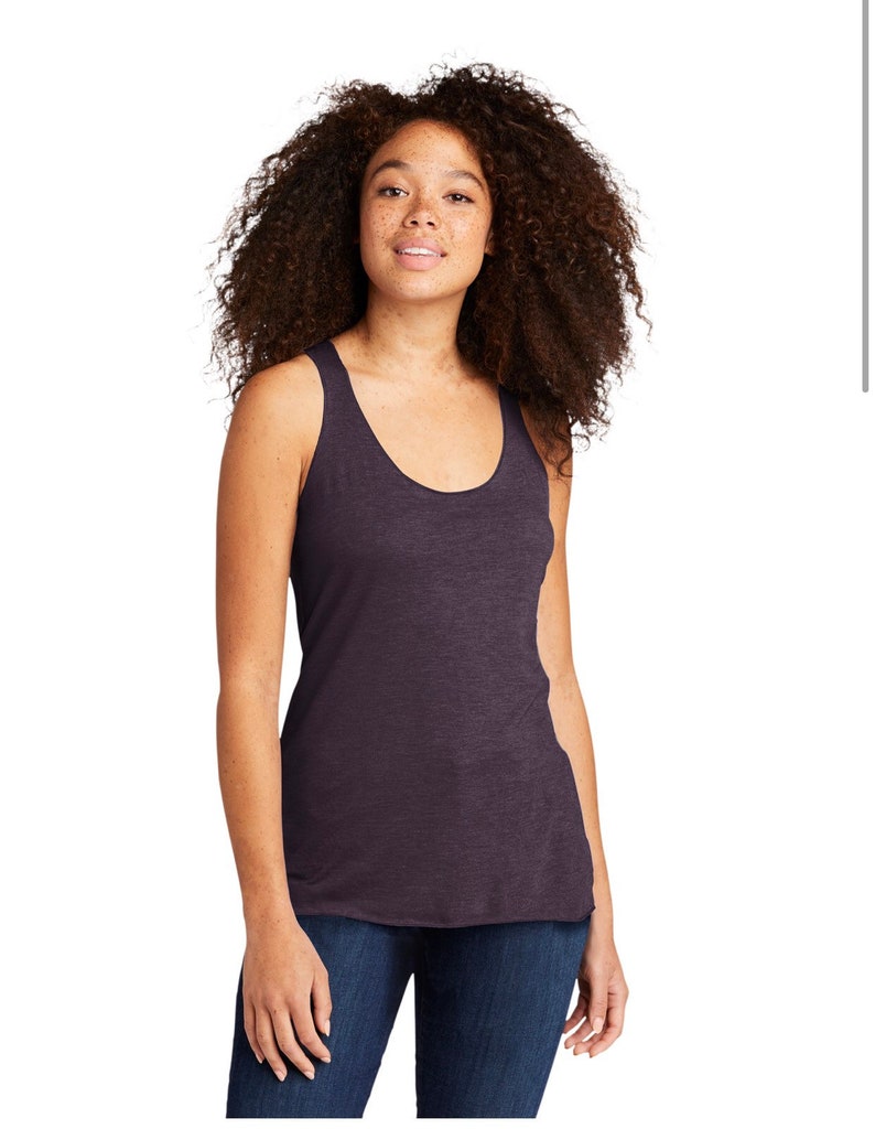 May include: A dark purple sleeveless tank top with a scoop neck. The tank top is made of a soft, comfortable fabric and has a relaxed fit.