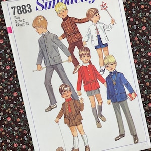 May include: Vintage Simplicity sewing pattern 7883 for boys' clothing. The pattern cover features illustrations of boys in various outfits, including suits, jackets, and shorts. The price is 65 cents, and the chest size is 21 inches.