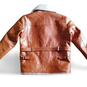 100% Genuine Leather: Premium cowhide/sheepskin leather for a luxurious look & feel.  Soft Shearling Fur Lining: Thick, warm, and breathable faux/sheepskin fur for extreme winter conditions. Classic Aviator Bomber Design: Inspired by WWII pilot jackets, offering a rugged, vintage vibe.  Custom Size Available: Need a perfect fit? Send us your measurements for a tailor-made jacket.  Ideal for Bikers & Riders: A motorcycle-friendly leather jacket, designed for comfort & durability.