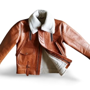 100% Genuine Leather: Premium cowhide/sheepskin leather for a luxurious look & feel.  Soft Shearling Fur Lining: Thick, warm, and breathable faux/sheepskin fur for extreme winter conditions. Classic Aviator Bomber Design: Inspired by WWII pilot jackets, offering a rugged, vintage vibe.  Custom Size Available: Need a perfect fit? Send us your measurements for a tailor-made jacket.  Ideal for Bikers & Riders: A motorcycle-friendly leather jacket, designed for comfort & durability.