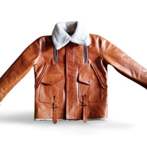 100% Genuine Leather: Premium cowhide/sheepskin leather for a luxurious look & feel.  Soft Shearling Fur Lining: Thick, warm, and breathable faux/sheepskin fur for extreme winter conditions. Classic Aviator Bomber Design: Inspired by WWII pilot jackets, offering a rugged, vintage vibe.  Custom Size Available: Need a perfect fit? Send us your measurements for a tailor-made jacket.  Ideal for Bikers & Riders: A motorcycle-friendly leather jacket, designed for comfort & durability.