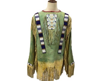 May include: A green leather jacket with fringe detailing and beaded accents. The jacket has a high neckline and long sleeves.