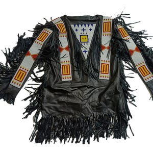 May include: A black leather jacket with fringe detailing and colourful beaded trim. The jacket has a V-neck and long sleeves.